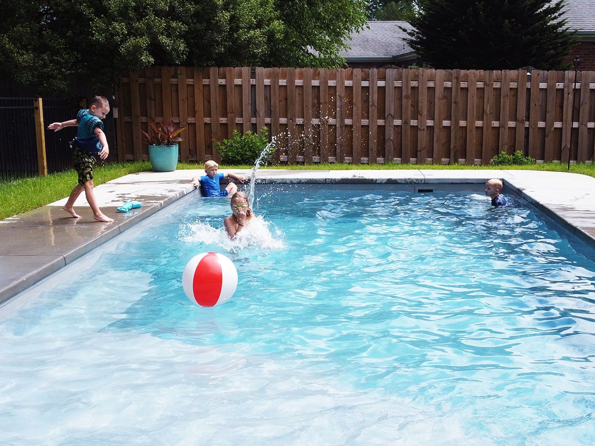 Childre playing in an in-ground fiberglass backyard pool in Louisville, Kentucky.