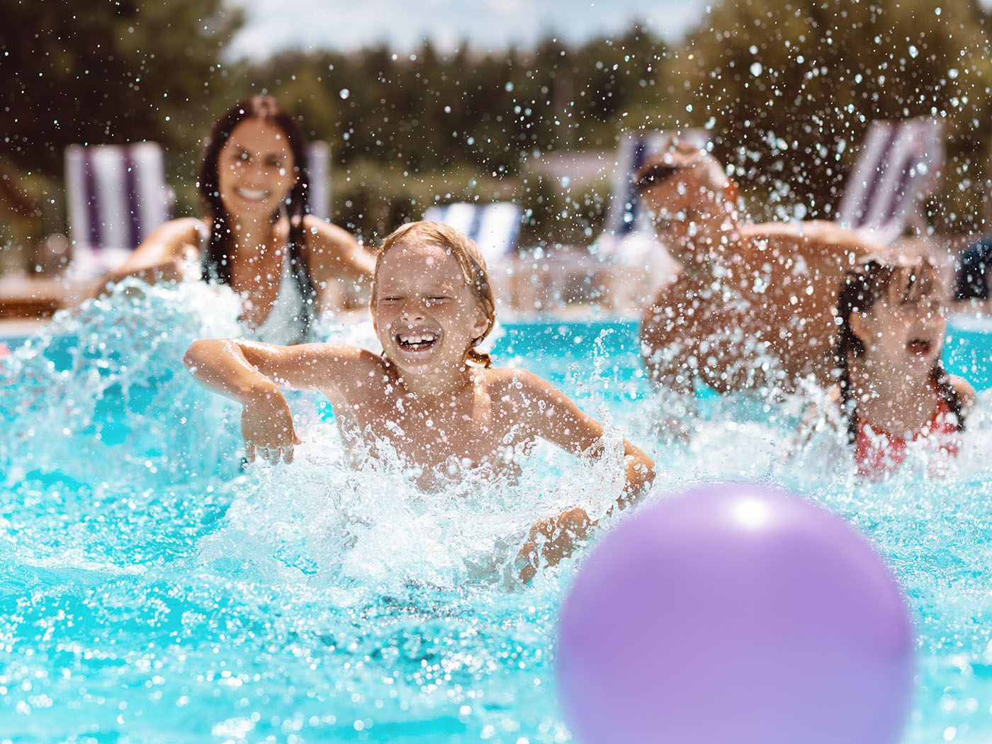 Family playing together in a pool.
