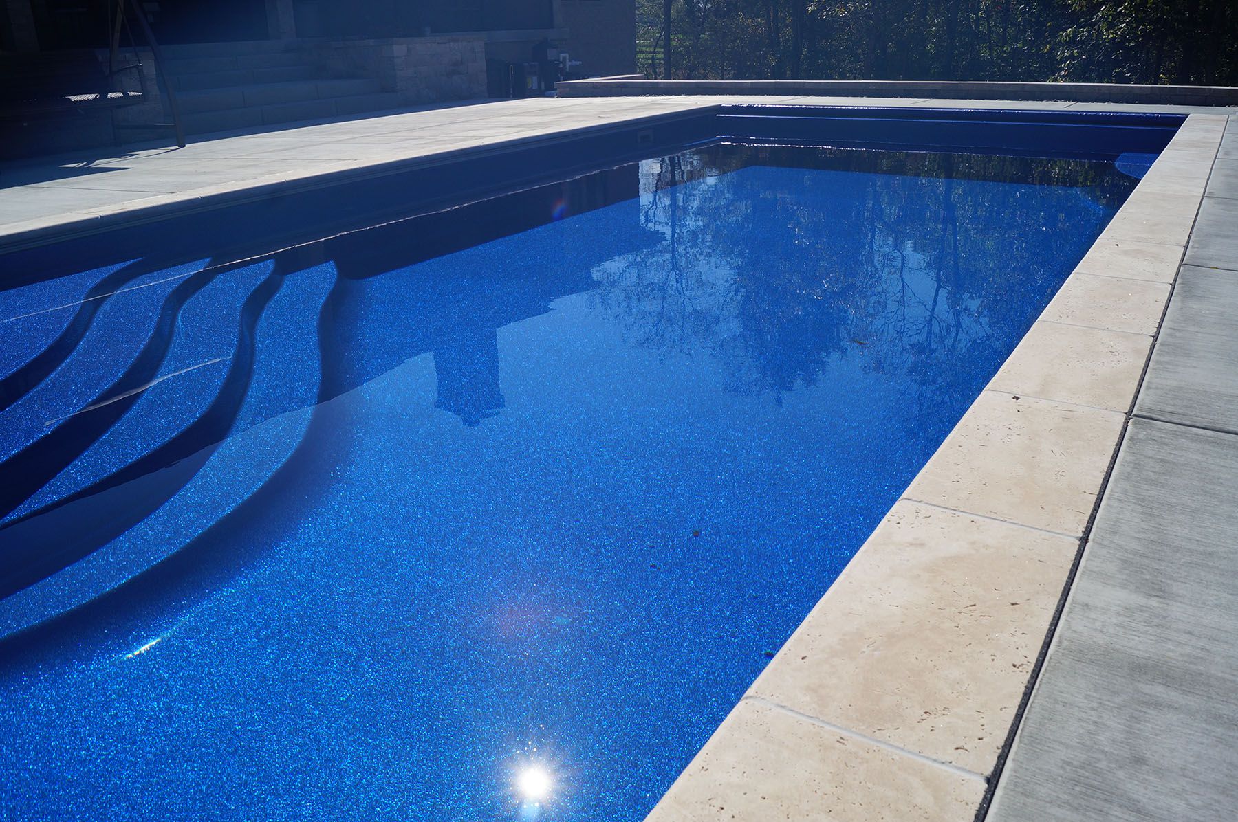Close up of a rectangular fiberglass in-ground backyard pool in Crestwood, Kentucky.