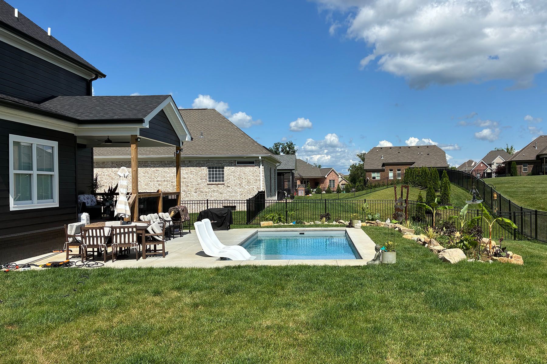 A rectangular fiberglass in-ground backyard pool in a nice neighborhood in Crestwood, Kentucky.