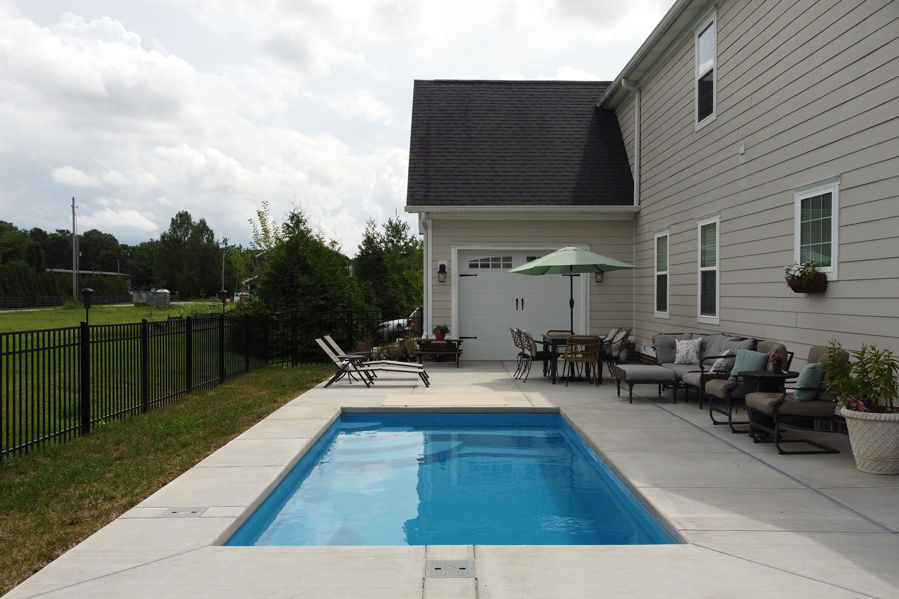 Rectangular backyard in-ground fiberglass swimming pool in Prospect, Kentucky.