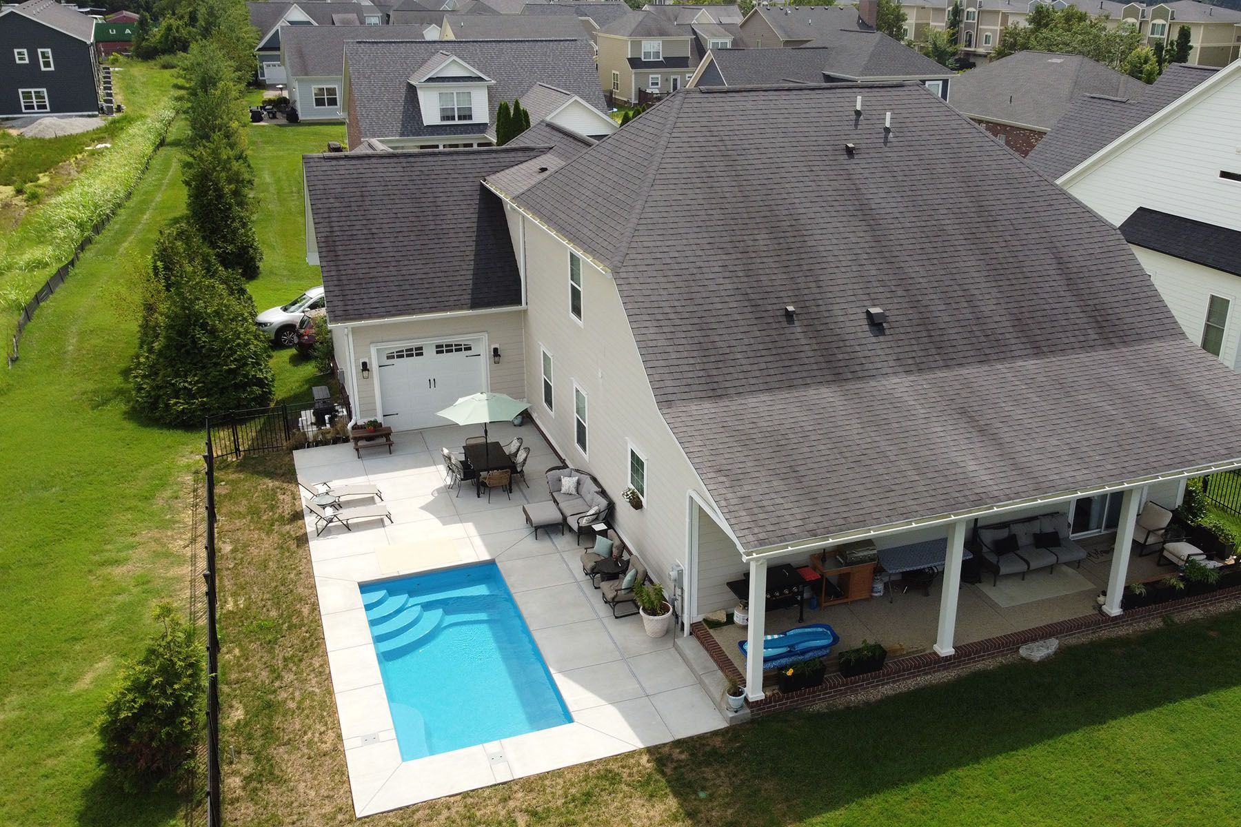 Aerial view of a rectangular backyard in-ground fiberglass swimming pool in Prospect, Kentucky.