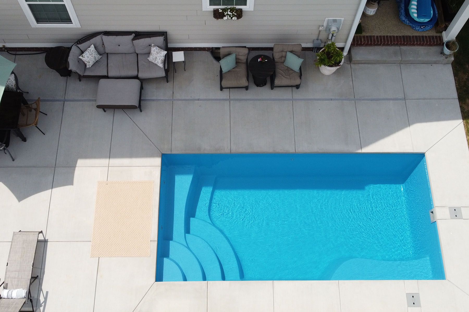 Aerial view of a rectangular backyard in-ground fiberglass swimming pool in Prospect, Kentucky.