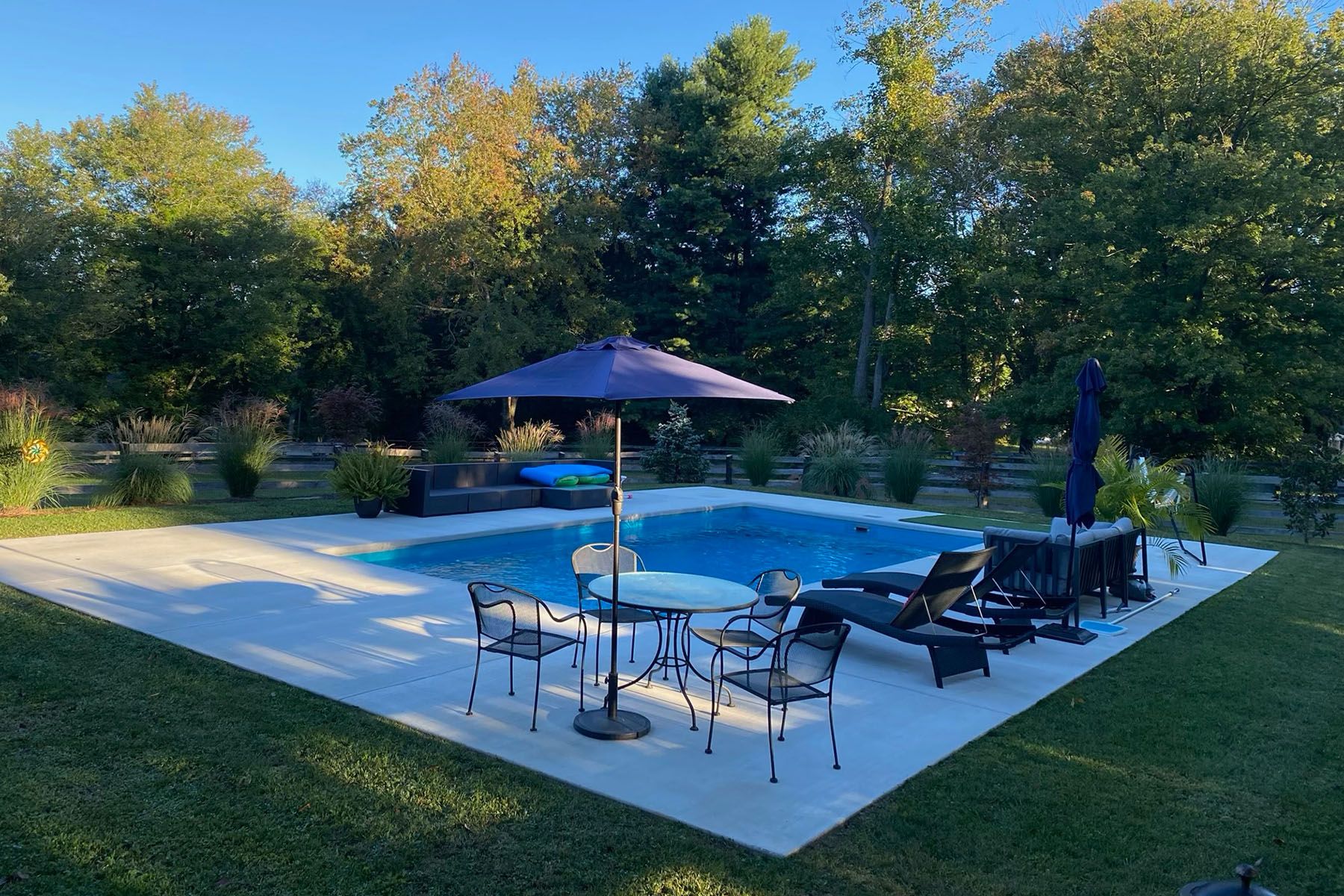 Rectangular in-ground fiberglass swimming pool in a nicely landscaped backyard in Prospect, Kentucky.