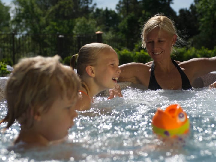 A mom and two kids tegether in an Asen Spa hot tub